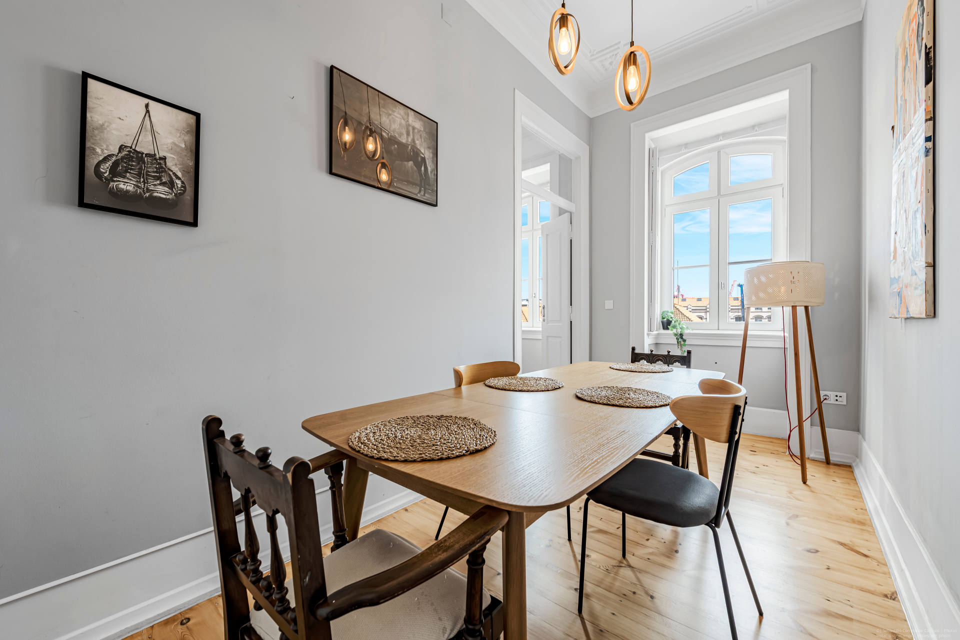 Dining room with wood table, high ceilings and natural light